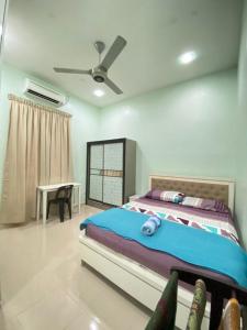 um quarto com uma cama e uma ventoinha de tecto em Family Homestay em Kuala Terengganu