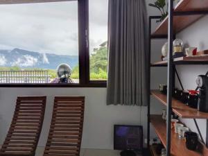 a room with a window with a view of a mountain at Yu Hai B&B in Jiaoxi