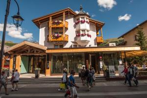 a group of people walking in front of a building at Hotel Concordia in Livigno