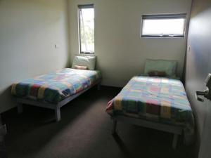 a bedroom with two beds and a window at Swansea Backpackers in Swansea