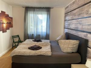 a small bedroom with a bed and a window at WinterbergerQuartier in Winterberg