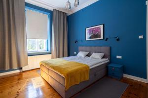 Posteľ alebo postele v izbe v ubytovaní Victus Apartamenty, Apartament Grand