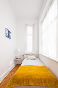 Posteľ alebo postele v izbe v ubytovaní Victus Apartamenty, Apartament Grand