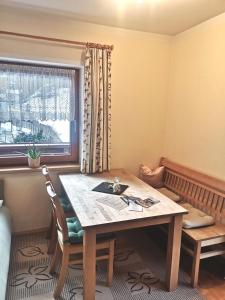 a dining room with a table and a window at Haus Grünberg in Finkenberg