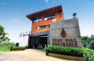 a building with a sign that reads pine hill residence at Pine Hill Residence in Kandy