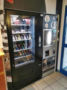 a black refrigerator filled with lots of drinks at ibis budget Nuits Saint Georges in Nuits-Saint-Georges