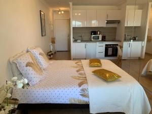a bedroom with a bed with two pillows on it at La Goelette - Palais des Festivals in Cannes