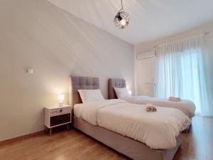 a bedroom with two beds and a window at WSD Muse Apartment Hotel in Athens