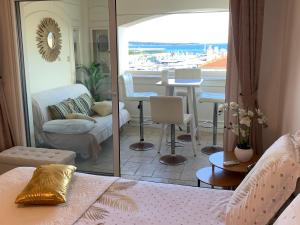 a bedroom with a view of a living room at La Goelette - Palais des Festivals in Cannes