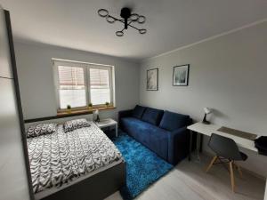 Łóżko lub łóżka w pokoju w obiekcie Apartamenty Promyk Wisełka