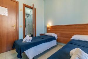 a hotel room with two beds and a shower at Hotel Beauty Palace - Vertex Group in Rome