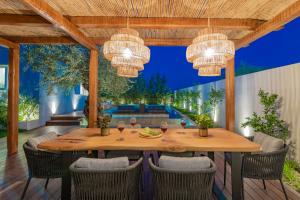 a dining room with a table and chairs at Oresteia Executive Villa, a Flamboyant Retreat, By ThinkVilla in Tragaki