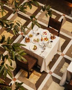a white table with plates of food on it at Hotel Copernicus in Krakow