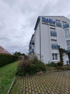 a building with a sign on the side of it at InTeck Hotel in Dettingen unter Teck