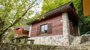 a small stone house with a window at Chata Michal in Ružomberok