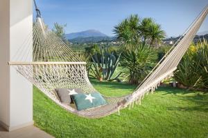 a hammock in a garden with a view at Villa Mexico-Con Piscina e Whirpool in Lazise