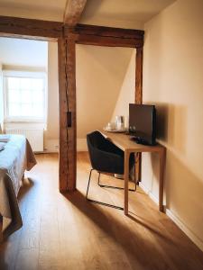 a bedroom with a desk with a computer on it at Kupfernams in Ventspils