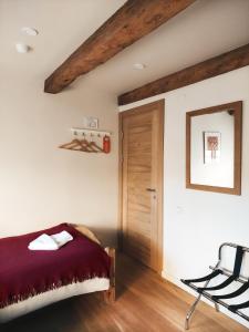 a bedroom with a bed and a wooden door at Kupfernams in Ventspils