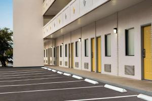 an empty hallway of a school building with yellow doors at Hotel Bo, a Days Inn by Wyndham Chattanooga Downtown in Chattanooga