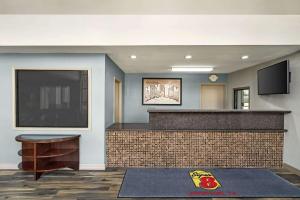 a lobby with a bar with a flat screen tv at Super 8 by Wyndham Houston Downtown I-610 in Houston