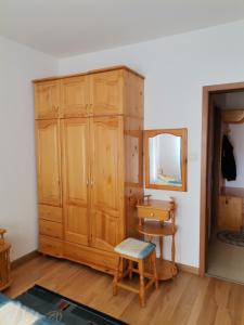 a room with a wooden cabinet and a mirror at Снежанка in Pamporovo