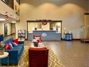 a living room with a blue couch and a table at Comfort Suites Near Casinos in Norwich