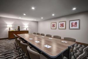 a conference room with a large wooden table and chairs at Staybridge Suites - Holland by IHG in Holland +41 photos