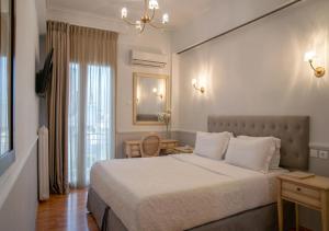מיטה או מיטות בחדר ב-Acropolis Ami Boutique Hotel