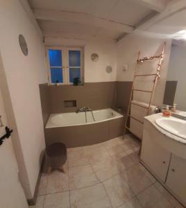 a bathroom with a bath tub and a sink at Chambre indépendante à la campagne in Puycalvel Lautrec +19 photos