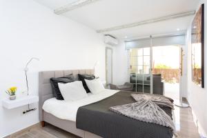 A bed or beds in a room at Home2Book Palm Beach & Relax Még 37 kép