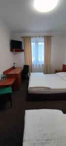 a hotel room with two beds and a window at Motel Port 2000 in Mostki