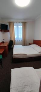 um quarto de hotel com duas camas e uma secretária em Motel Port 2000 em Mostki