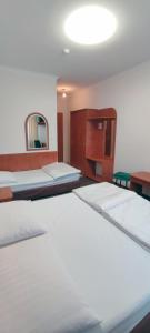 a room with two beds and a mirror at Motel Port 2000 in Mostki
