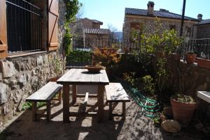 una mesa de picnic y un banco en un jardín en casa rural Aaiun, en Riópar