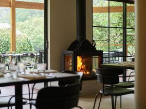 a fireplace in a restaurant with tables and chairs at Kyah in Blackheath