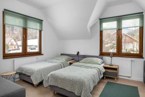 Postel nebo postele na pokoji v ubytování Tylko Tu i Teraz- Sauna, Balia z jacuzzi, Bon turystyczny
