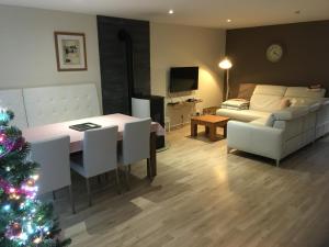 a living room with a christmas tree and a couch at la Rose sur Meuse in Haybes