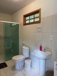 uma casa de banho com um WC, um lavatório e um chuveiro em Casa Amarela na praia para 13 pessoas em Ilhéus