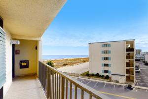 a balcony with a view of a building and the beach at Sea Time 407S in Ocean City