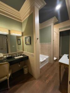 a bathroom with two sinks and a bath tub at The Inn at Houmas House Estate in Darrow +37 photos