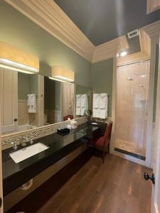 a bathroom with a sink and a large mirror at The Inn at Houmas House Estate in Darrow