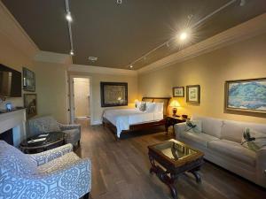 a bedroom with a bed and a living room at The Inn at Houmas House Estate in Darrow