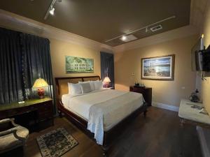 a bedroom with a large bed and a television at The Inn at Houmas House Estate in Darrow