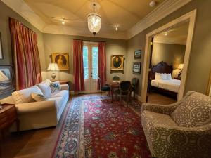 a living room with a couch and a mirror at The Inn at Houmas House Estate in Darrow