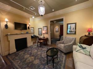 a living room with a couch and a fireplace at The Inn at Houmas House Estate in Darrow