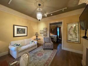 a living room with a couch and a chair at The Inn at Houmas House Estate in Darrow