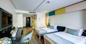 a hotel room with two beds and a television at The Elysium Styles Taksim in Istanbul