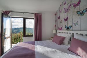 a bedroom with a bed with butterflies on the wall at Motovun Bellevue - amazing view, comfortable in Livade