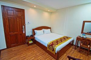 Postel nebo postele na pokoji v ubytování Royal Pearl Hotel