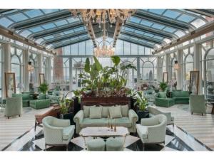 a lobby with green furniture and a chandelier at Kaya Palazzo Resort & Casino in Kyrenia